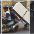 Napoli, trasportano frigorifero con lo scooter