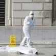 Investigative police officers works by a body under a white sheet outside Marseille 's main train station Sunday, Oct. 1, 2017 in Marseille, southern France. A man with a knife attacked people at the main train station in the southeastern French city of Marseille on Sunday, killing two women before soldiers fatally shot the assailant, officials said. (ANSA/AP Photo/Claude Paris) [CopyrightNotice: Copyright 2017 The Associated Press. All rights reserved.]