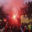 Soccer fans light flares and clamber atop Police vans before their Champions League, Semi Final First Leg soccer match between Liverpool and Roma, at Anfield in Liverpool, England, Tuesday April 24, 2018. (Peter Byrne/PA via AP) [CopyrightNotice: PA Wire]